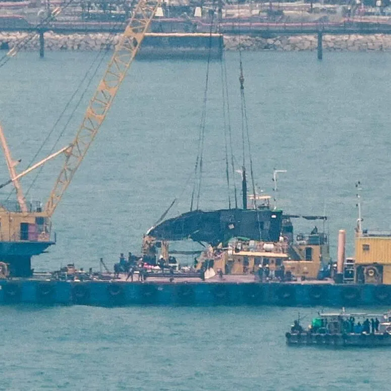 In photos of the salvage operations taken on March 30, a yellow crane can be seen on a floating platform, with its jib extending upwards.