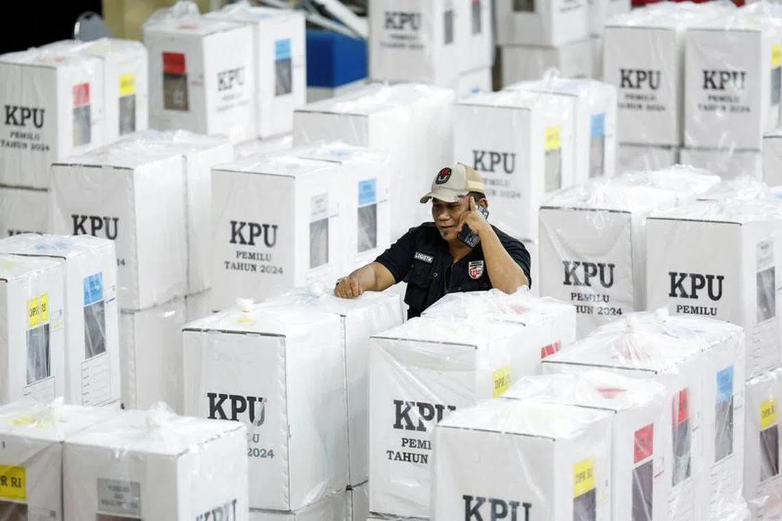 An election commission officer speaks on a phone, as he stands among ballot boxes prepared for the upcoming general election, in Jakarta, Indonesia, February 6, 2024. REUTERS/Willy Kurniawan/ File photo