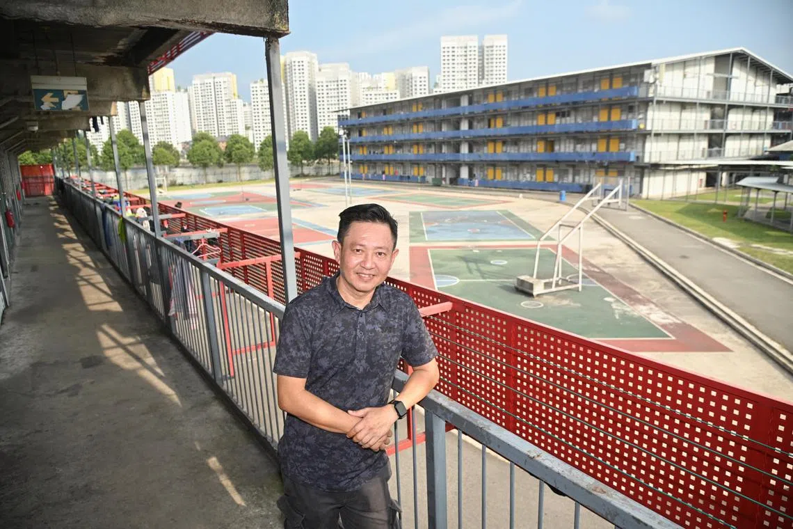 Mr Kelvin Low, General Manager, Director. 
Tee Up Dormitory Pte. Ltd. Standing in front of the open ground where the several basketball and sepak takraw courts are existing. A seventh floor dormitory will be Built on this site . 

Photo was taken on 11 October 2023 at PPT Lodge 1A. 8 Seletar North Link, 797455





By 2030, about 1,000 foreign worker dormitories will need to meet an interim set of infrastructural standards meant to improve their ability to contain disease outbreaks. The Ministry of Manpower (MOM) said on Wednesday that by 2040, these 1,000 existing dorms will have to upgrade to even higher standards that were unveiled in 2021.