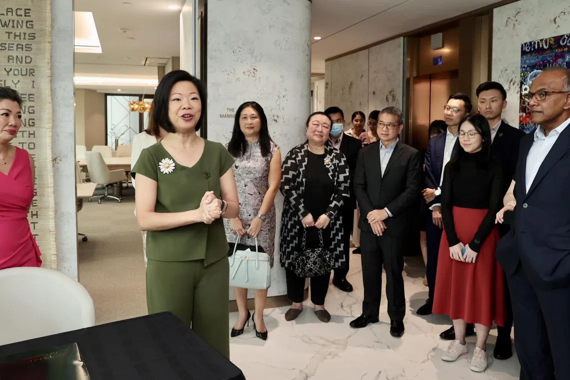Senior Minister of State Sim Ann (second left), together with Minister for Law K. Shanmugam (right) and Second Minister for Law Edwin Tong (fifth from right) at the opening of the SheCares @SCWO centre on Jan 11, 2023.