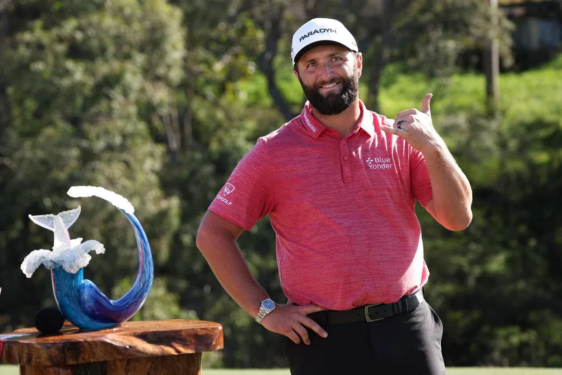 Jon Rahm of Spain celebrating with the trophy after winning the Tournament of Champions at Plantation Course at Kapalua Golf Club on Sunday. 