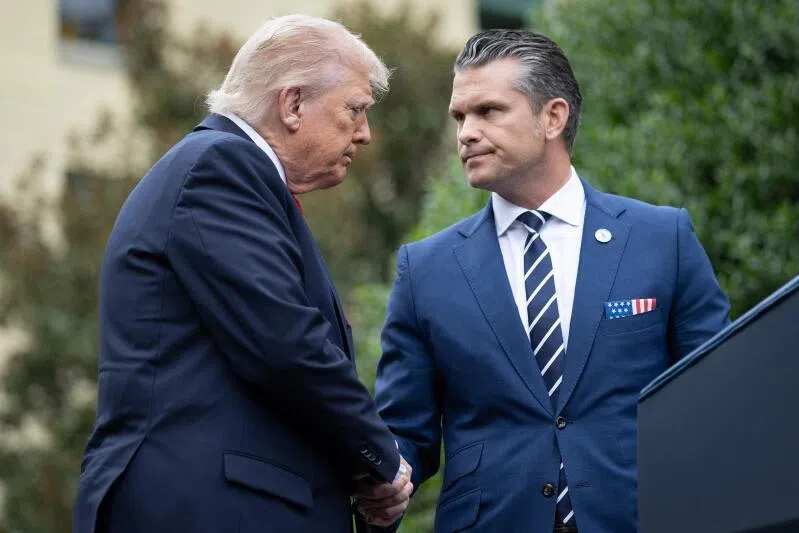 US President Donald Trump greets Secretary of War Pete Hegseth (right) during an event at the Pentagon in Arlington, Virginia, on Sept 11, 2025.