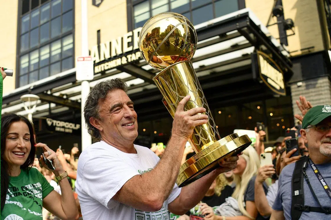 Owner Wyc Grousbeck of the Boston Celtics holding the Larry O'Brien Championship Trophy during the 2024 Boston Celtics championship parade.