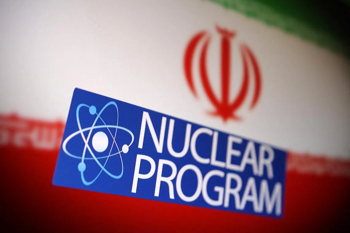 Iranian flag, atom symbol and words \"Nuclear program\" are in this illustration taken June 16, 2025. REUTERS/Dado Ruvic/Illustration