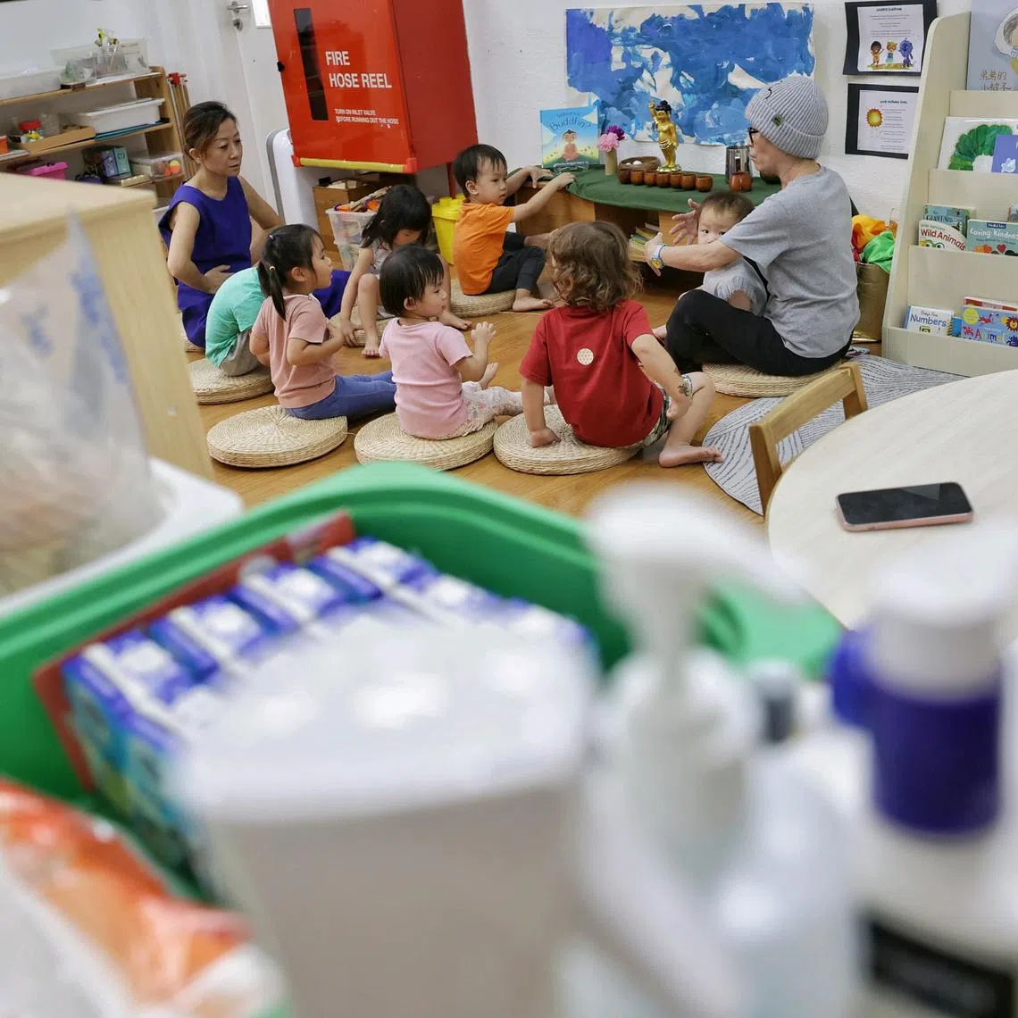 Children from playgroup and nursery one taking part in the opening circle, where they meditate and help clean the altar of Baby Buddha, at Blue Lion Preschool on Aug 7, 2024. Smaller independent preschools face increasing challenges amid competition against government supported preschools.