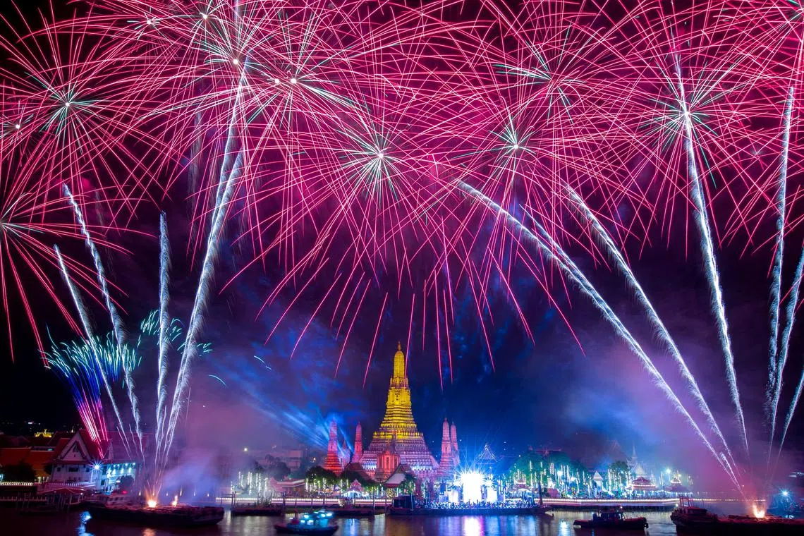 Fireworks explode over Wat Arun of the temple of dawn during the New Year celebrations, in Bangkok, Thailand, Jan 1, 2023.