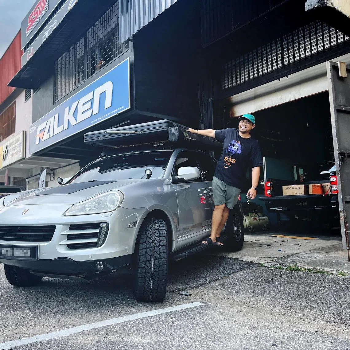 Mr Iylia Kwan, posing with his Malaysian-registered 2009 Porsche Cayenne SUV, which he bought secondhand for RM50,000 (S$15,000) in 2022.