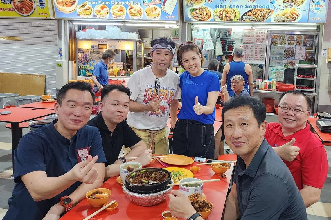 Health Minister Ong Ye Kung (foreground, right) dined at ABC Brickworks Market and Food Centre with Tanjong Pagar GRC MP Eric Chua (foreground, left) on Jan 14.