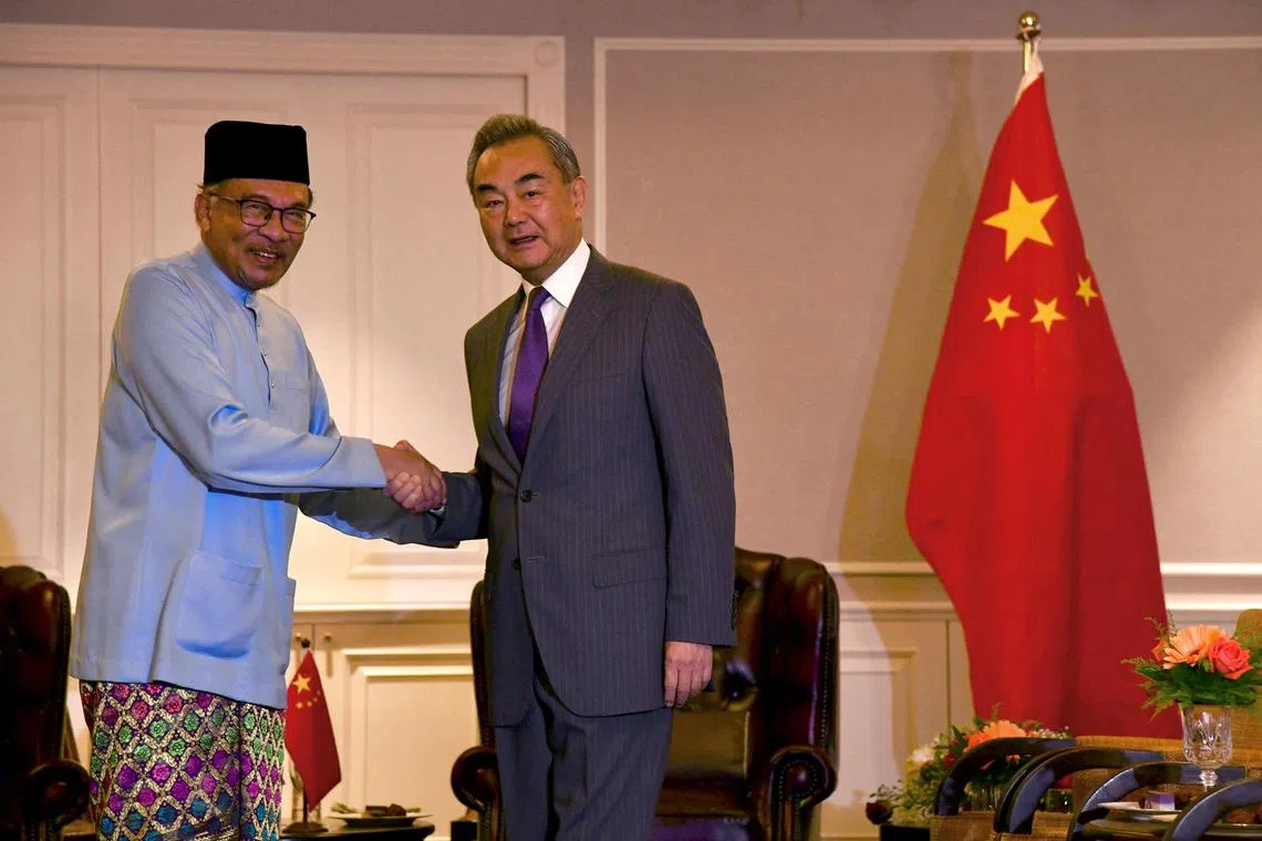 Malaysian PM Anwar Ibrahim shakes hand with Chinese Foreign Minister Wang Yi during the latter's visit to Penang.