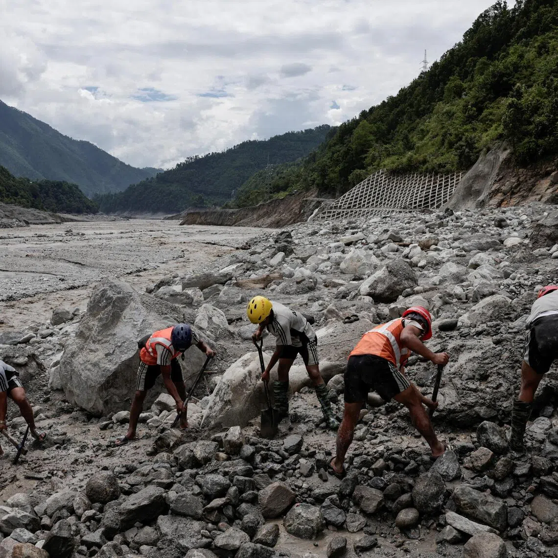 A rescue team works to clear the path towards the tunnel at Upper Trishuli 3B Hydropower Station.