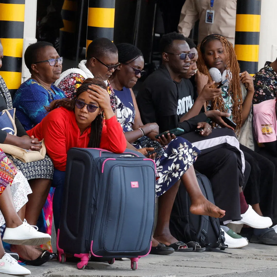 Stranded travellers wait with their luggage after their flight operations were disrupted due to a strike by workers at the Jomo Kenyatta International Airport (JKIA) in Nairobi, Kenya, August 30, 2026. REUTERS/Monicah Mwangi