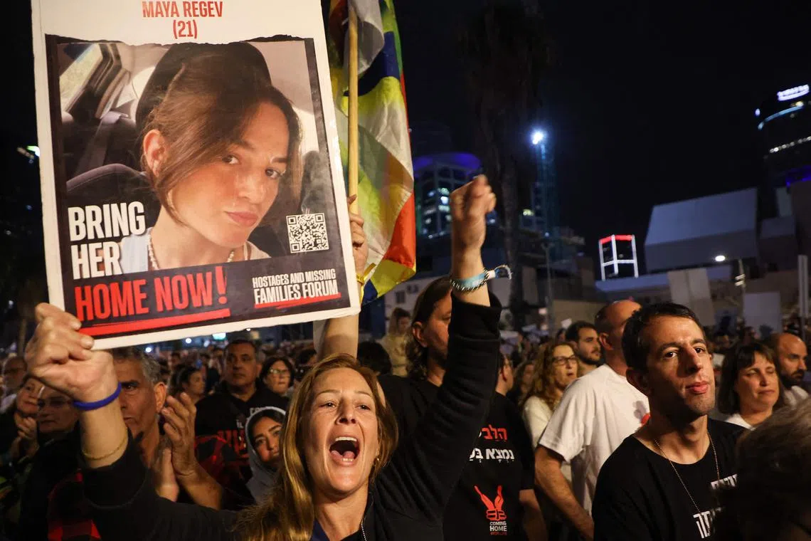 Relatives of 21-year-old Maya Regev take part in a protest asking for the release of Israeli hostages, in Tel Aviv, on Nov 25, 2023.