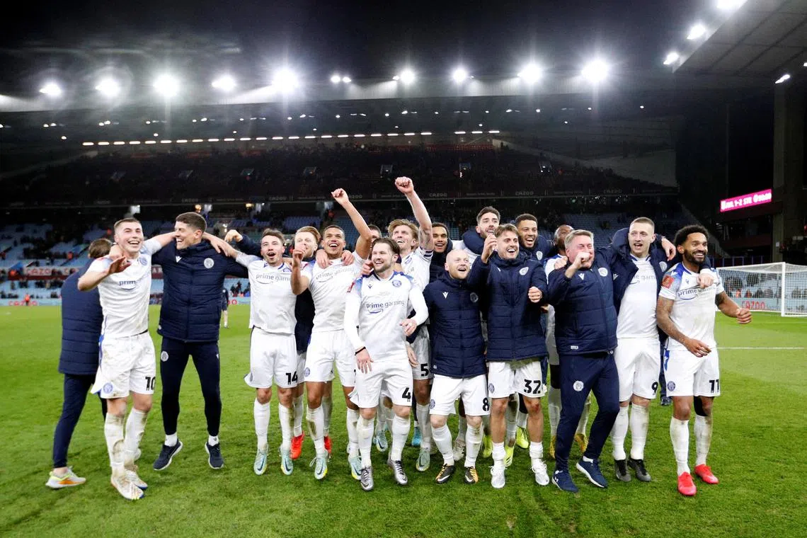 Stevenage's assistant manager Paul Raynor, first-team coach Alex Revell and players celebrate after they stunned Premier League side Aston Villa in the third round of the FA Cup.      