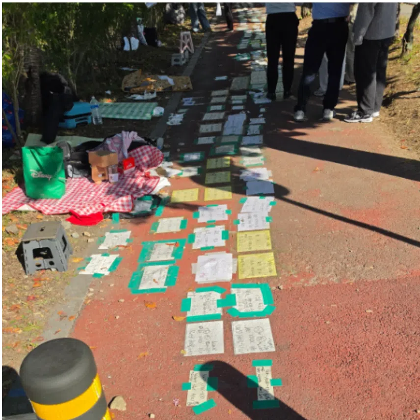 The sheets of paper were marked with dates, phone numbers and the number of people in each group to indicate that the spots had been claimed.