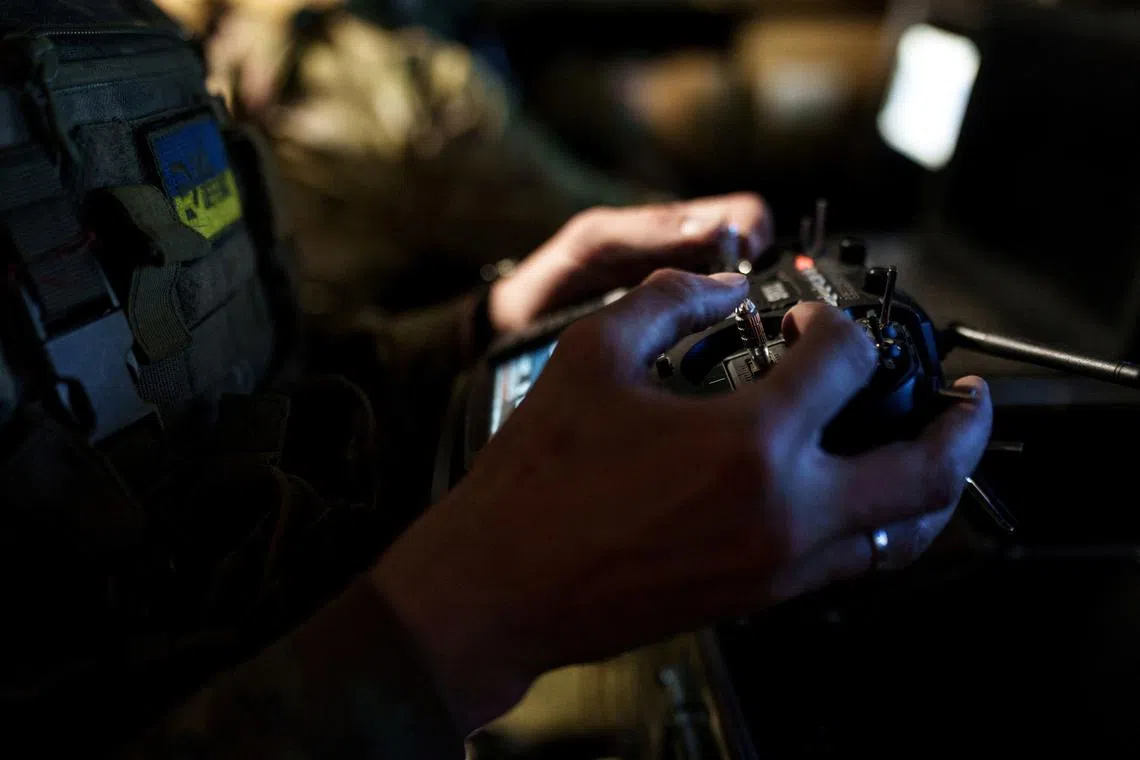 FILE PHOTO: A service member of a drone unit of the 24th Separate Mechanized Brigade named after King Danylo of the Ukrainian Armed Forces controls a heavy combat drone while it flies over positions of Russian troops, amid Russia's attack on Ukraine, in Donetsk Region, Ukraine June 12, 2025. REUTERS/Serhii Korovainyi/File Photo