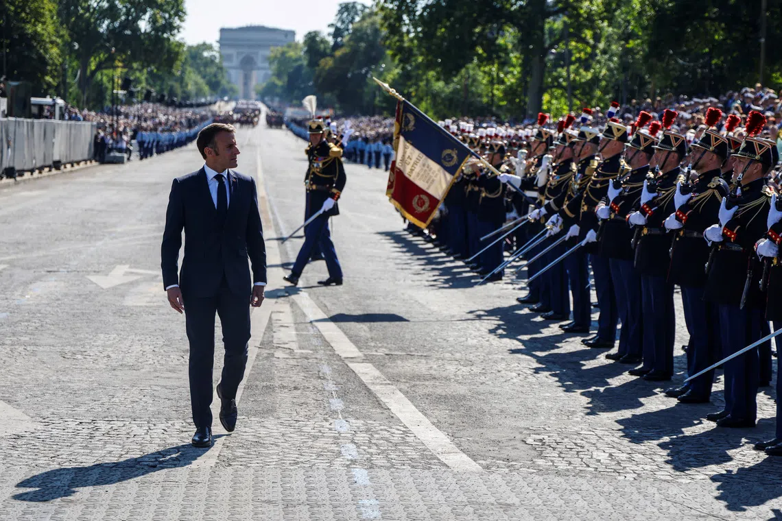 France's President Emmanuel Macron reviews the troops during the Bastille Day military parade on the Avenue Foch with the Arc de Triomphe in background, in Paris, France on July 14, 2024.  LUDOVIC MARIN/Pool via REUTERS/File Photo