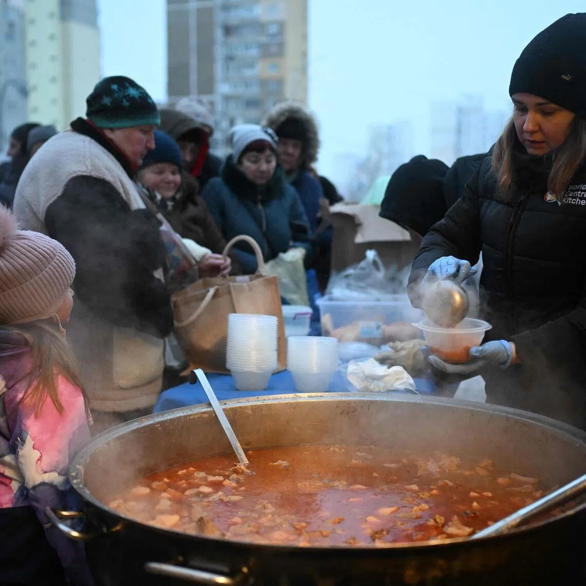 Volunteers of US-based food charity World Central Kitchen distributing a hot meal on Jan 22 to residents in Kyiv, which has been left without electricity and water due to Russian strikes on Ukraine's energy sector.