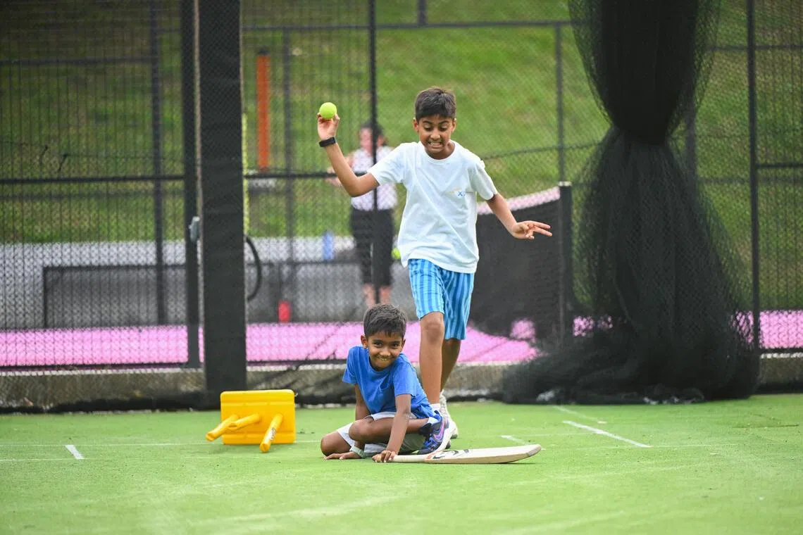 Brothers Jay (in blue shirt), seven, and Neel Ramnarayan, ten, launched a Migrant Worker Premier League which kicked off in May.