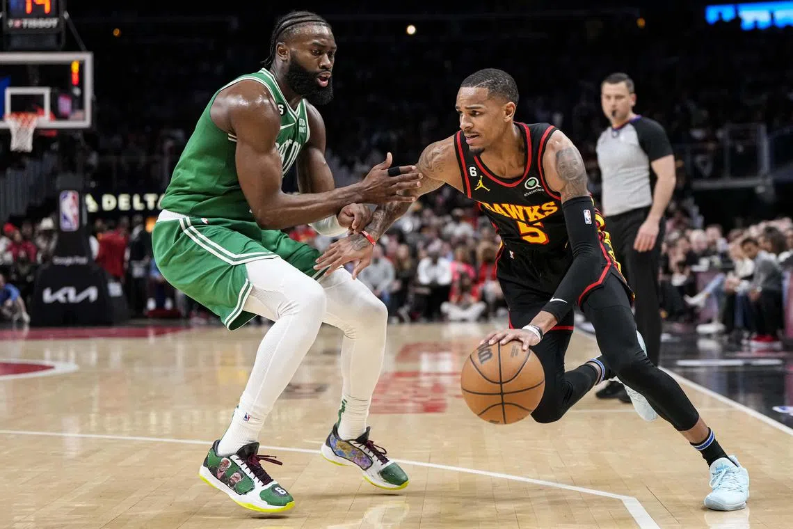 Atlanta Hawks guard Dejounte Murray, pictured dribblig against Boston Celtics guard Jaylen Brown in Game 4,  will miss the  next play-off game after he was suspended.