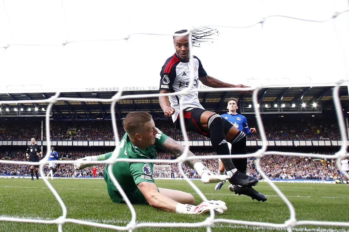 Fulham's Bobby Decordova-Reid scores past Everton's Jordan Pickford.