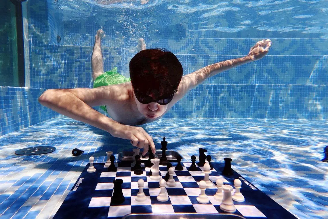 Chess - Grand Masters compete in Diving Chess Competition - Silo Hotel, Cape Town, South Africa - December 4, 2025 Uzbekistan's Javokhir Sindarov in action against Hans Niemann of the U.S. REUTERS/Esa Alexander