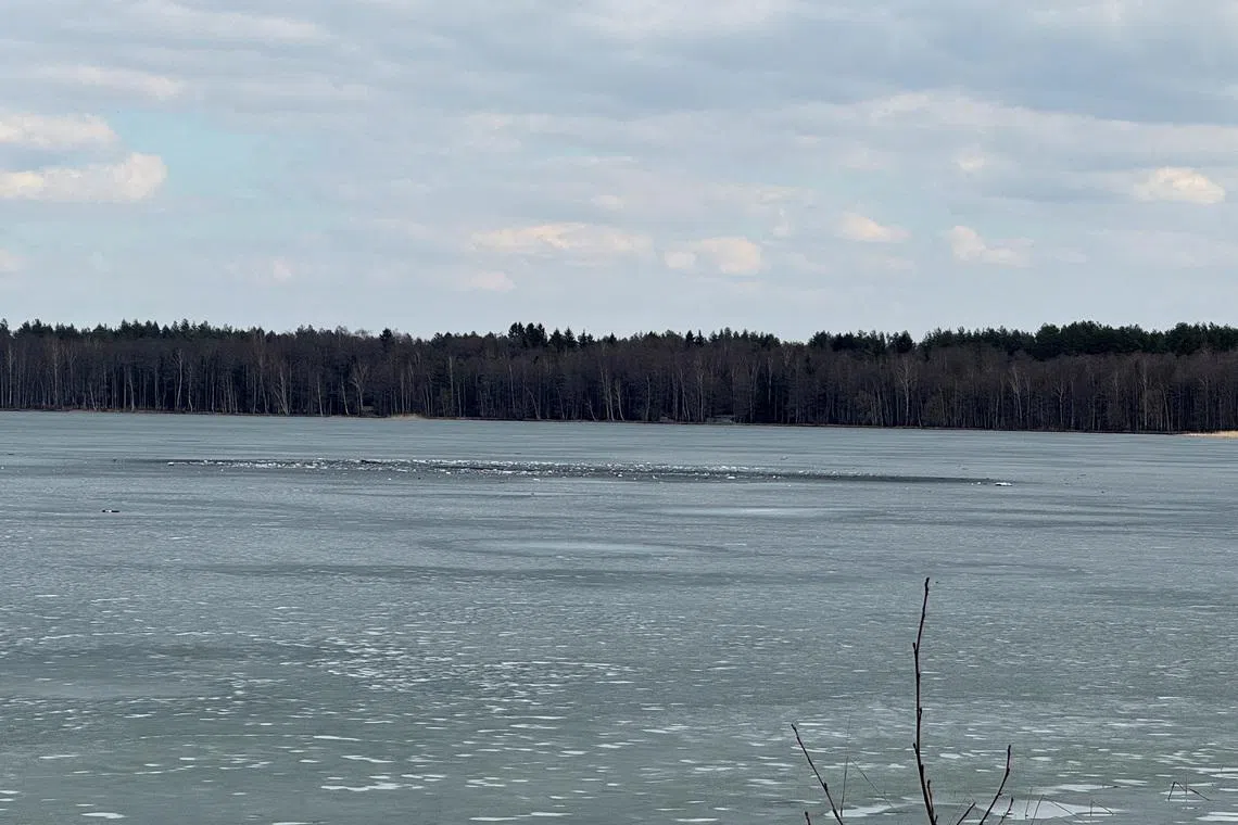 Debris lies across an ice-covered lake where Lithuania's army says that a suspected drone crashed into after entering the country's airspace, in Lavysas, Lithuania, March 23, 2026. Vytautas Lebednykas and Karolis Lebednykas/Handout via REUTERS