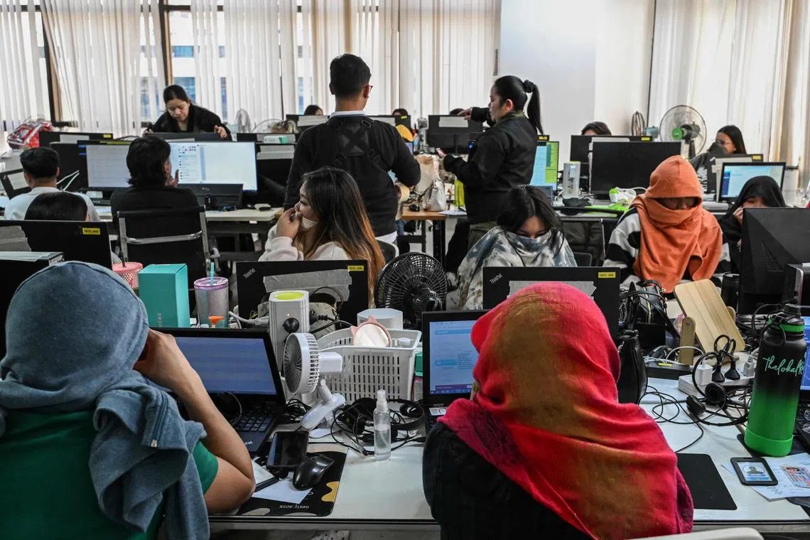 Police agents raid a suspected online scam farm in the Philippine capital Manila on Jan 31.