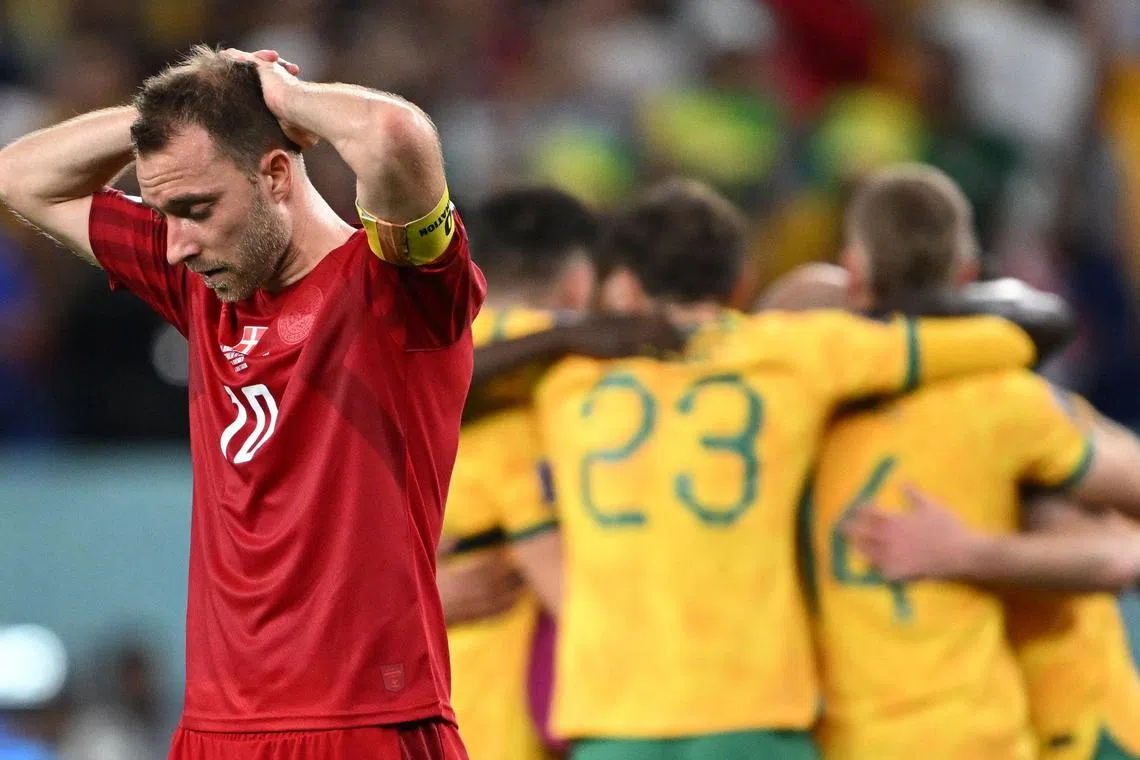 Denmark's midfielder Christian Eriksen (left) reacts after Australia wins the match.
