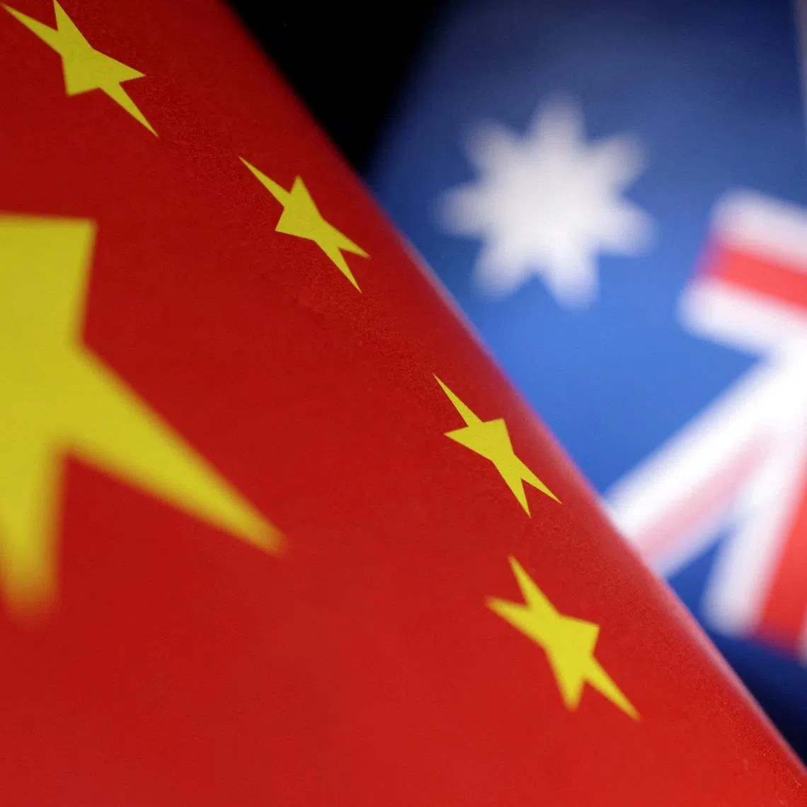 FILE PHOTO: Printed Chinese and Australian flags are seen in this illustration, July 21, 2022. REUTERS/Dado Ruvic/Illustration/File Photo