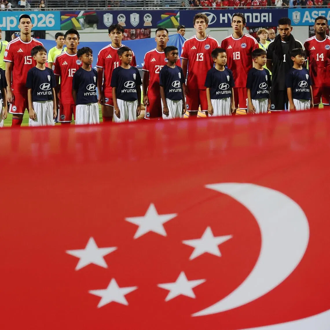 Lions players singing the national anthem during the ASEAN Championship Group A match against Indonesia at the Jalan Besar Stadium on Aug 7.