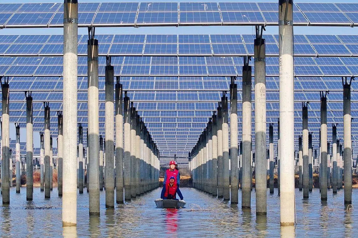 Workers checking solar panels installed on a lake in Tianchang, east China's Anhui province, on Jan 12, 2026.