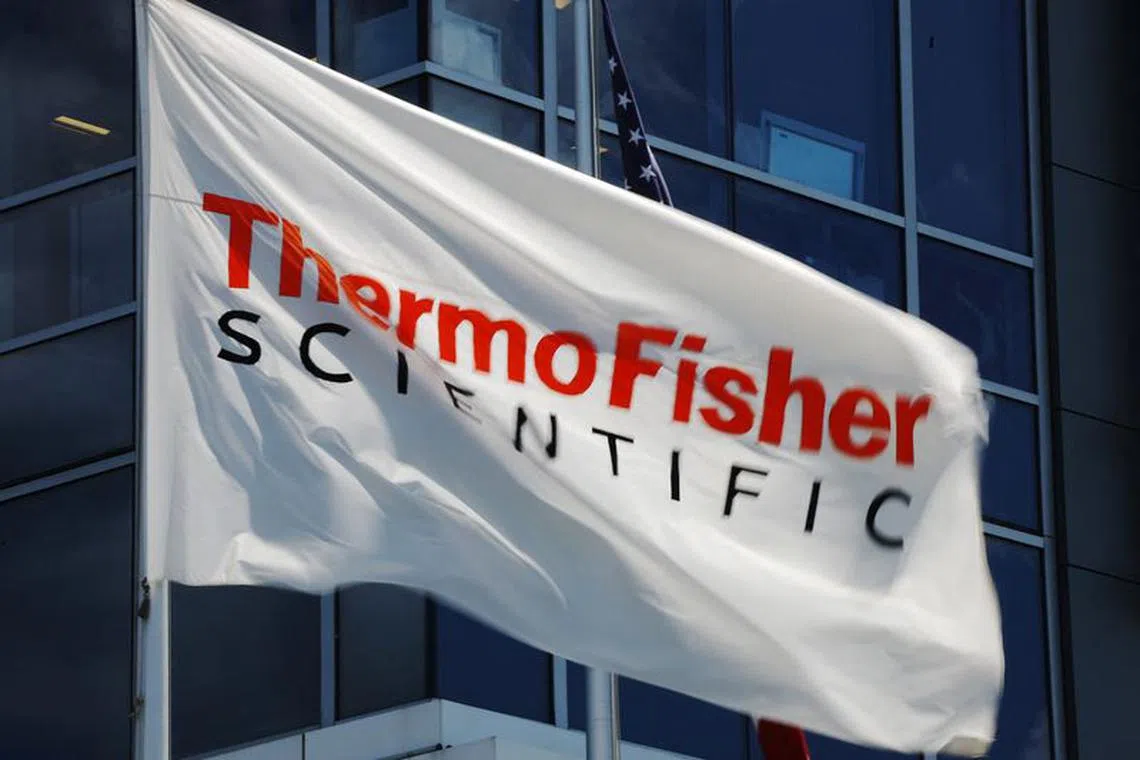 A company flag flies outside the offices of Thermo Fisher Scientific offices in Waltham, Massachusetts, U.S., August 2, 2023.     REUTERS/Brian Snyder/file photo