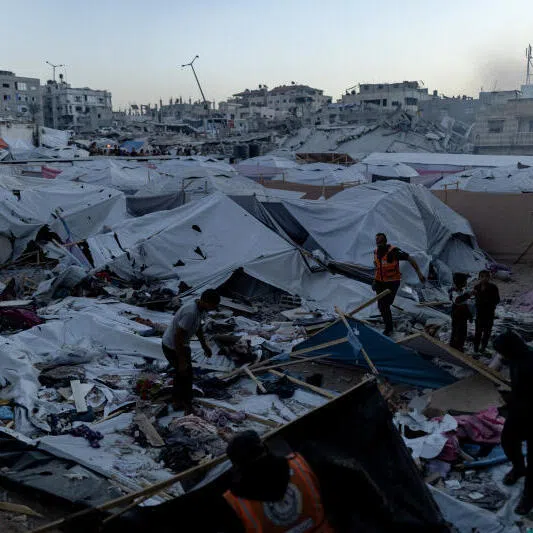 People look over damage after an Israeli airstrike in western Gaza City, on Nov 22.