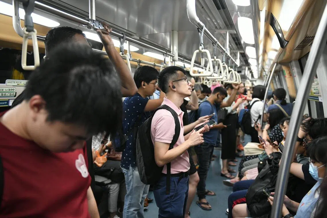 Commuters on a train stopping at Kovan MRT station at about 9.35pm on March 29, 2023.