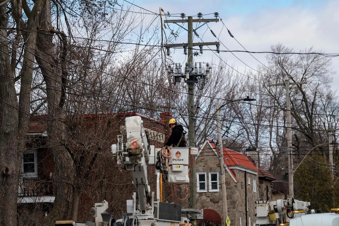 Hydro Quebec employees work on fixing power lines in Montreal.
