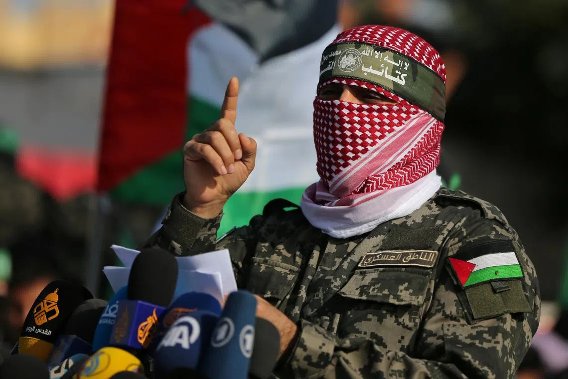 Abu Ubaida, the spokesman of the Izz el-Deen al-Qassam Brigades, gestures as he speaks during an anti-Israel military show in the southern Gaza Strip November 11, 2019. REUTERS/Ibraheem Abu Mustafa/ File Photo