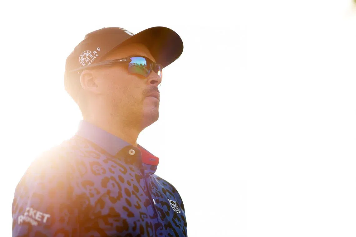 Rickie Fowler of the United States walking from the 18th tee during the third round of the Rocket Mortgage Classic at Detroit Golf Club on Saturday in Detroit. He tops the leaderboard on 20-under 196 after 54 holes.