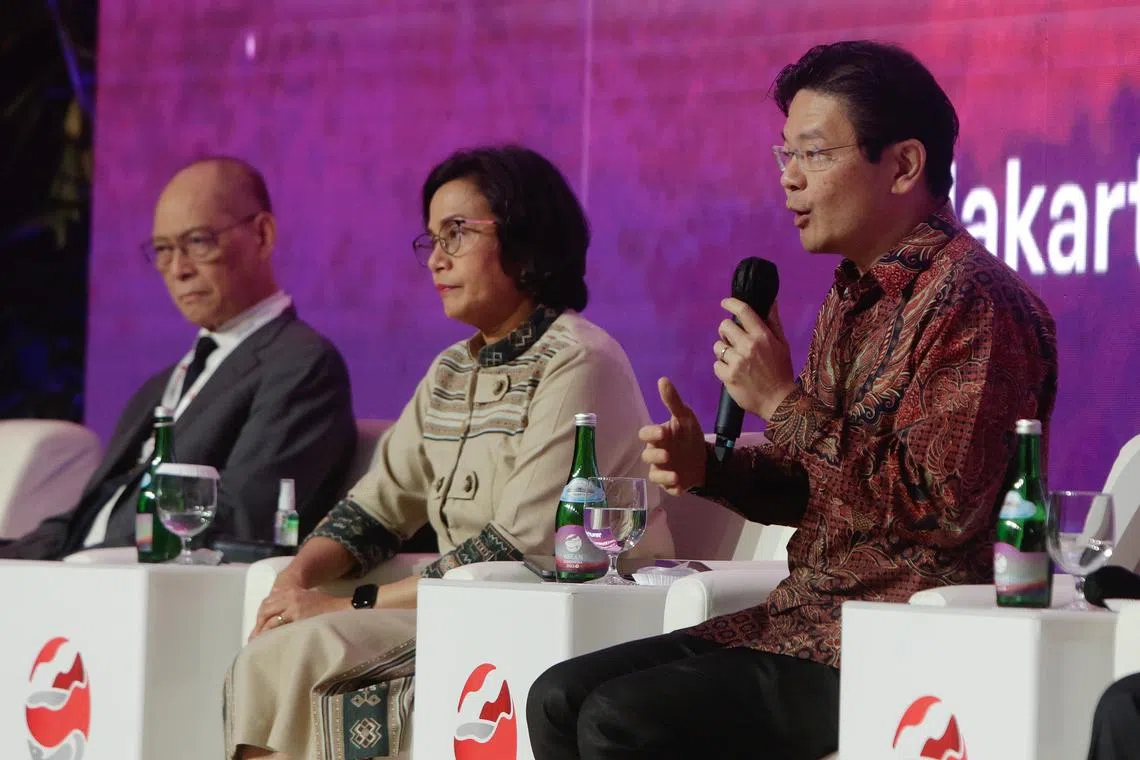 DPM Lawrence Wong (right) speaks at a side event of the Asean Ministerial and Central Governors meeting in Jakarta on Aug 24, with Philippines Deputy Finance Minister Benjamin E. Diokno (left) and Indonesian Finance Minister Sri Mulyani (centre) in attendance.