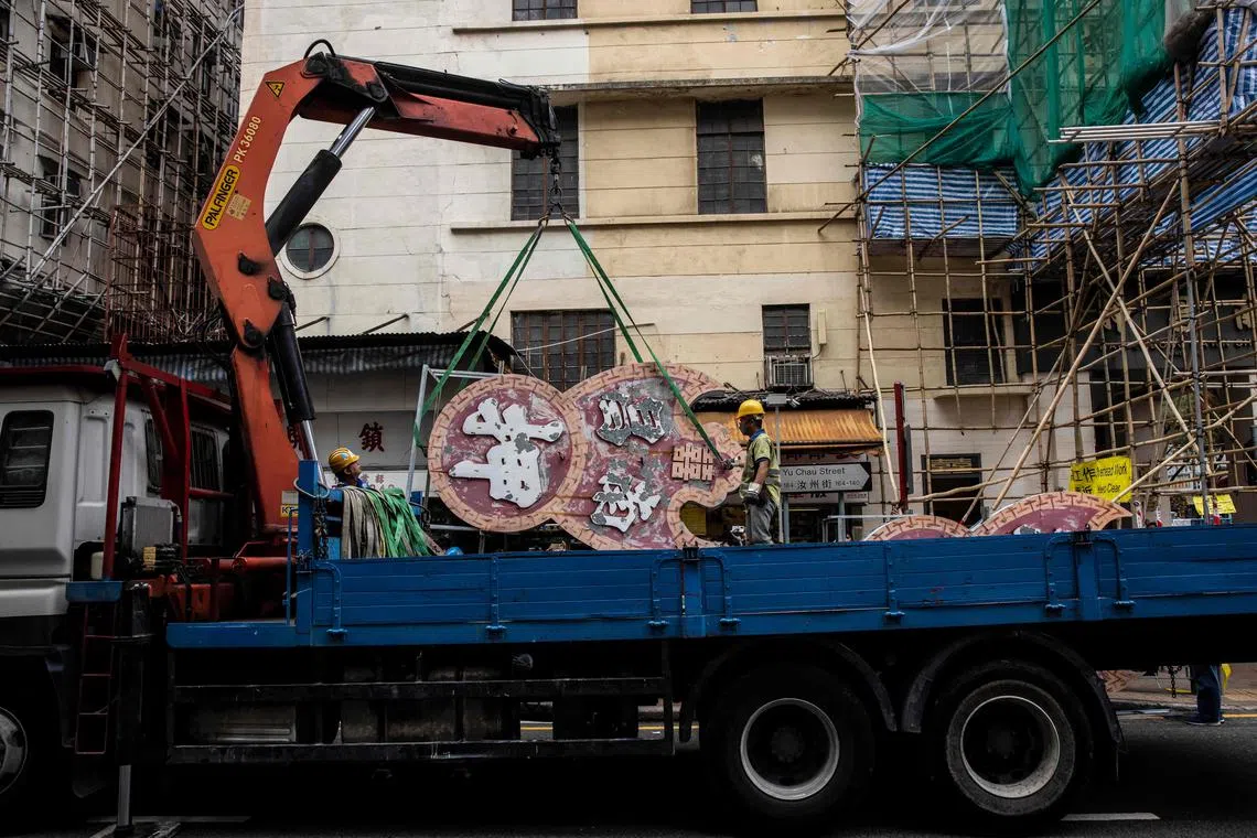 Conservation group Tetra Neon Exchange (TNX) loading the Nam Cheong Pawn Shop neon sign on to a truck to be taken to their storage yard, March 13, 2023. 
