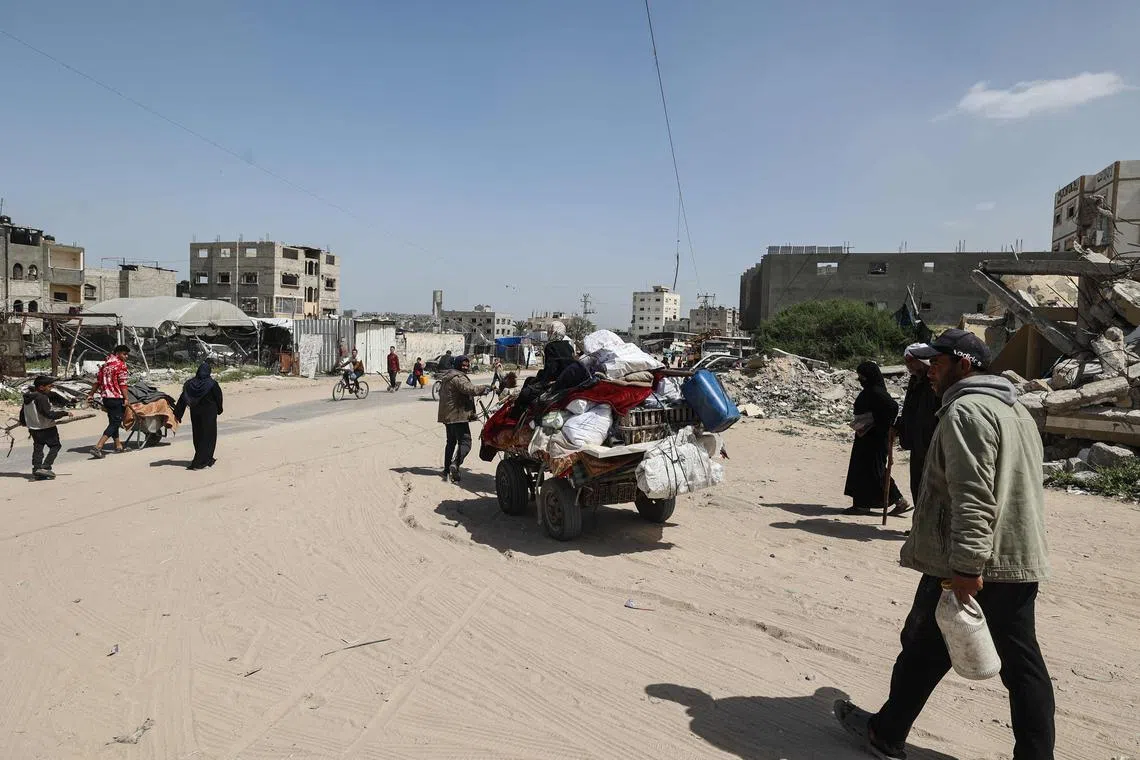 Palestinians transport their belongings as they flee Rafah towards Khan Yunis in the southern Gaza Strip, on April 2.