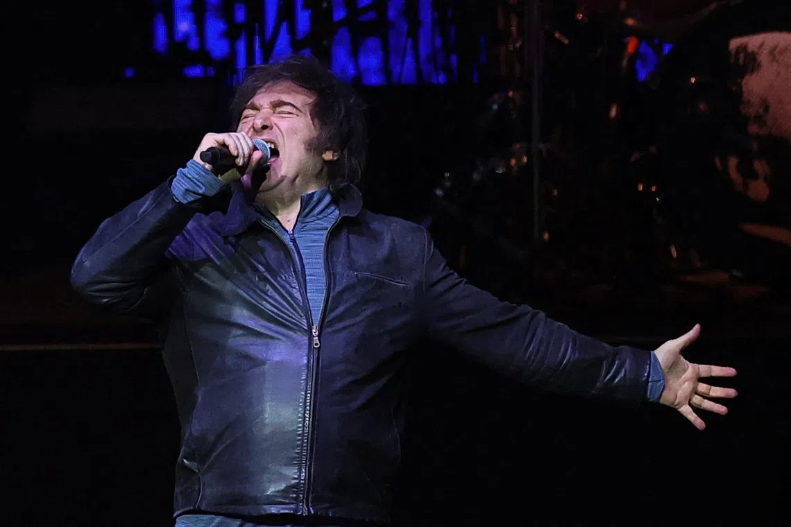 Argentine President Javier Milei sings with his band during the presentation of his book \"Construction of the Miracle\", at the Movistar Arena, in Buenos Aires, Argentina, October 6, 2025. REUTERS/Agustin Marcarian
