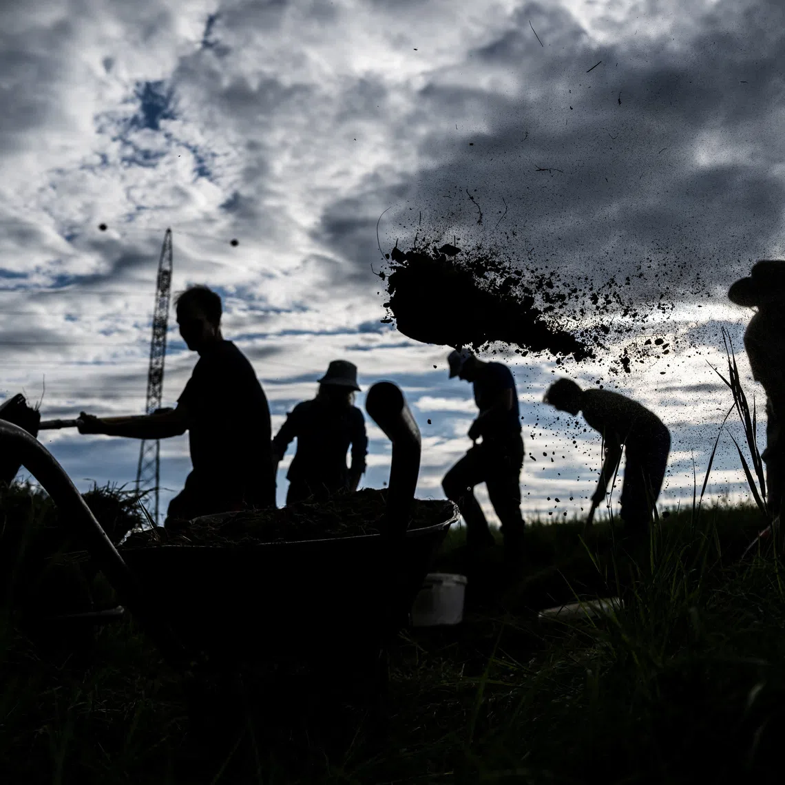 Members of a water conservation group, Water Guardians Movement, work to retain water in the landscape near Budapest, Hungary, June 12, 2026. Volunteers are turning out in their hundreds to help the country build structures to retain rainwater and restore wetlands, techniques that mark a sharp turnaround from the past, when programmes focused on managing floods, not droughts.  REUTERS/Marton Monus