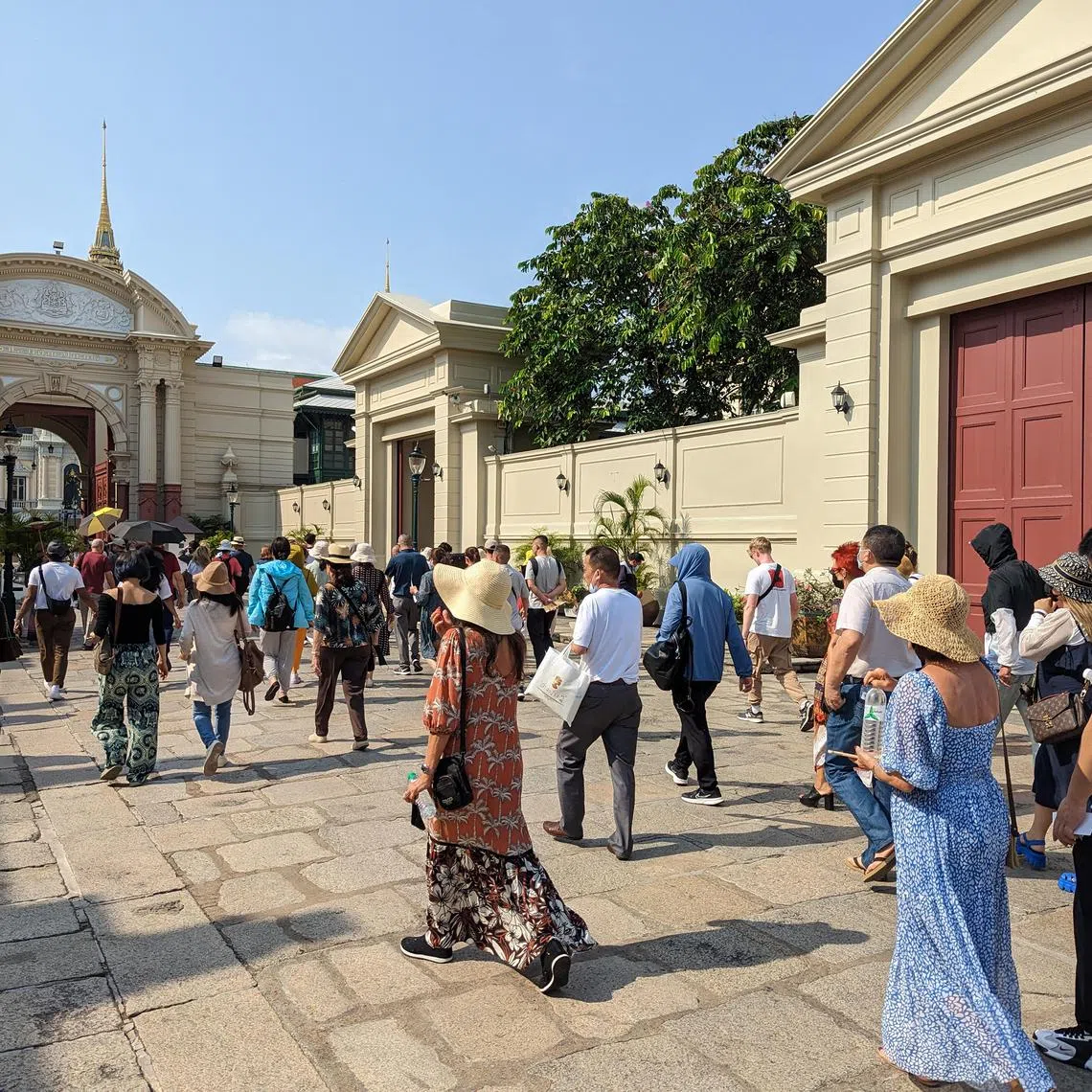 Chinese tour groups make their way into the Grand Palace in Bangkok.