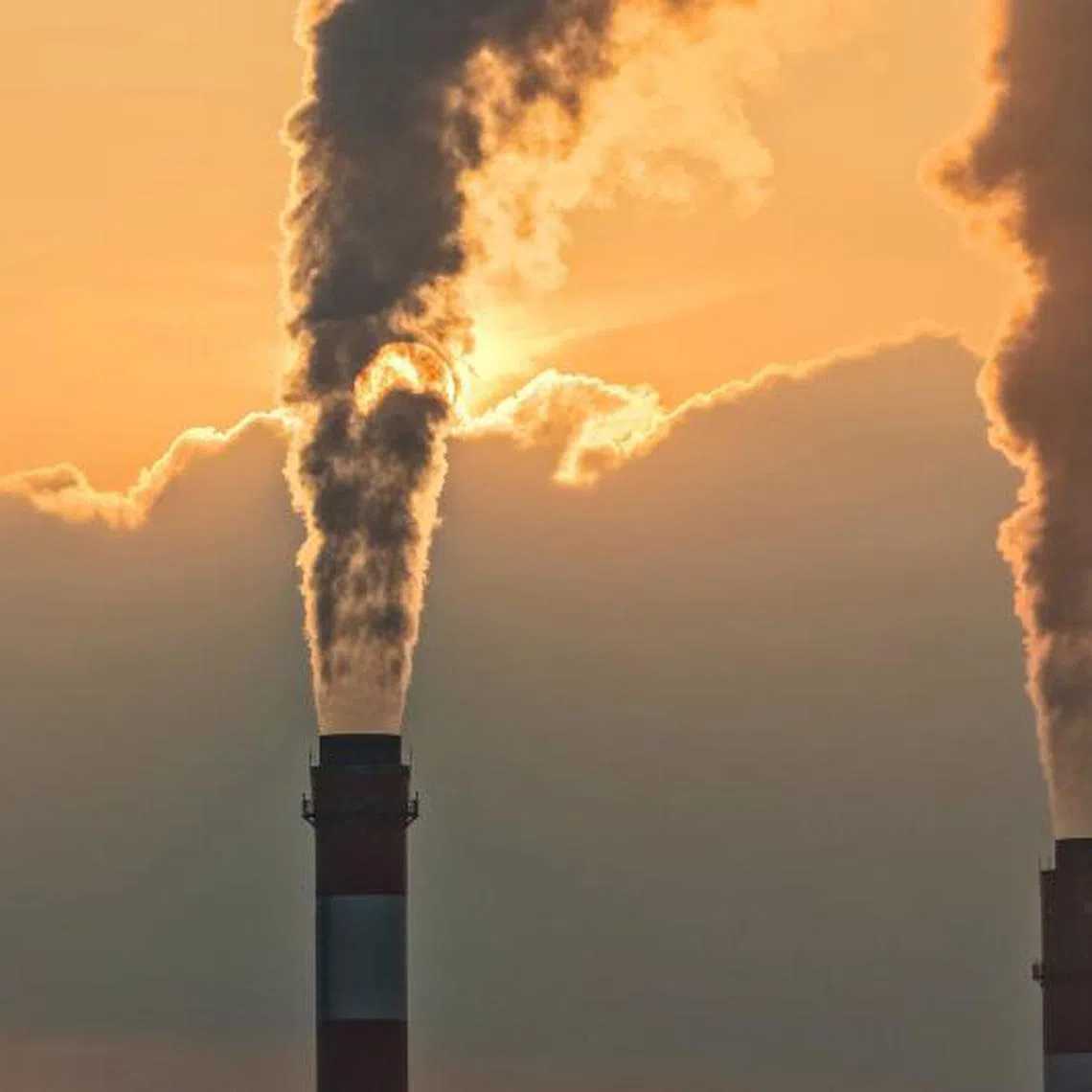 Smoke rising from chimneys at a power plant during sunset in Taicang, in eastern China's Jiangsu province.