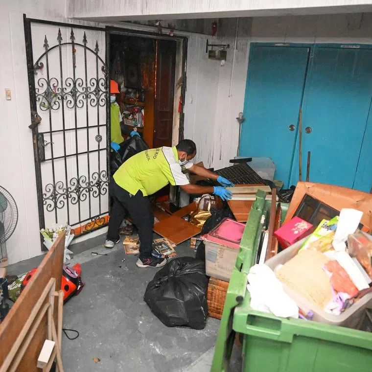 Town council staff clearing items from the flat in Hougang Street 91 on Jan 10, 2025, a day after a fire broke out in the unit. 