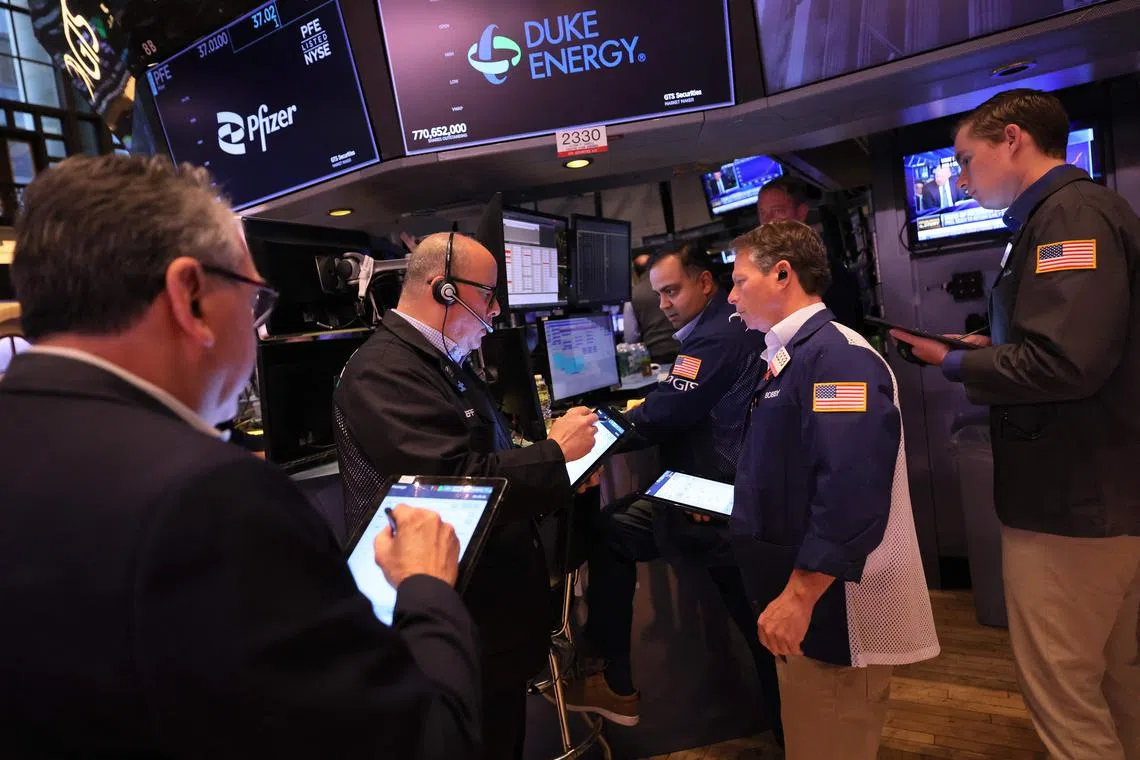 Traders work on the floor. Markets will be closely watching for the outcome of the US debt ceiling negotiations this week.slightly high after dropping over 300 points at closing on Tuesday as congressional leaders and President Joe Biden work to finalize a deal on the U.S. debt ceiling in order to avoid a default.   Michael M. Santiago/Getty Images/AFP (Photo by Michael M. Santiago / GETTY IMAGES NORTH AMERICA / Getty Images via AFP)