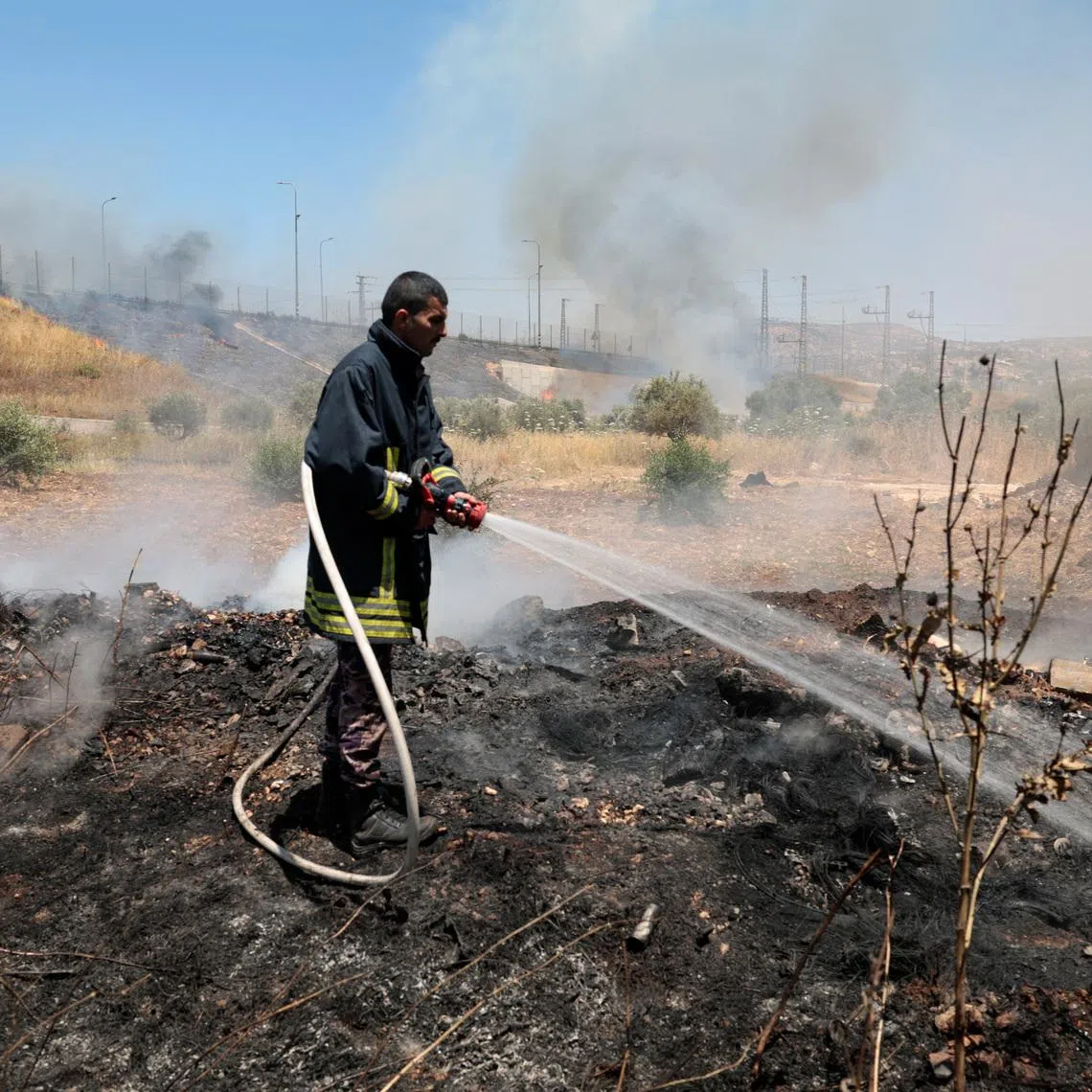 A Palestinian man rushes to extinguish fire in a field, which local Palestinians say has been set by Israeli settlers, in the town of Huwwara near Nablus, in the Israeli-occupied West Bank, June 6, 2026. REUTERS/Mohamad Torokman