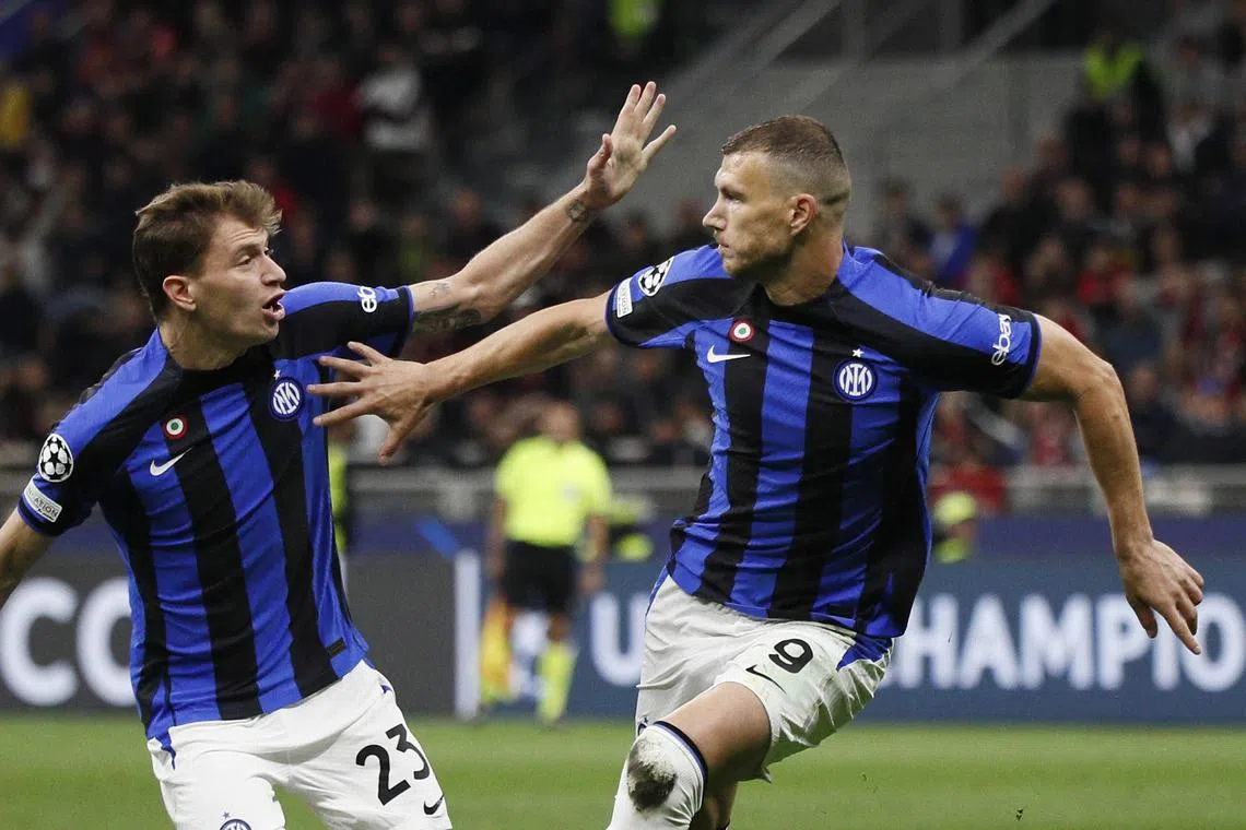 Inter Milan's Edin Dzeko celebrates scoring their first goal with Nicolo Barella.