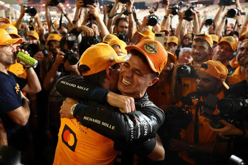 McLaren's Lando Norris celebrates with his teammate Oscar Piastri and the rest of his team after becoming the 2025 Formula One world champion.