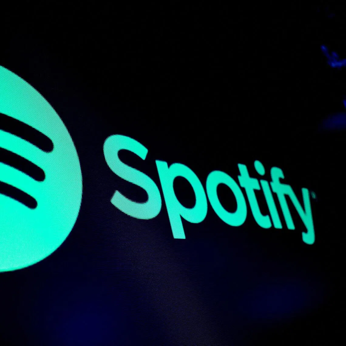 FILE PHOTO: A screen displays the logo of Spotify on the floor at the New York Stock Exchange (NYSE) in New York City, U.S., December 4, 2023.  REUTERS/Brendan McDermid/File Photo